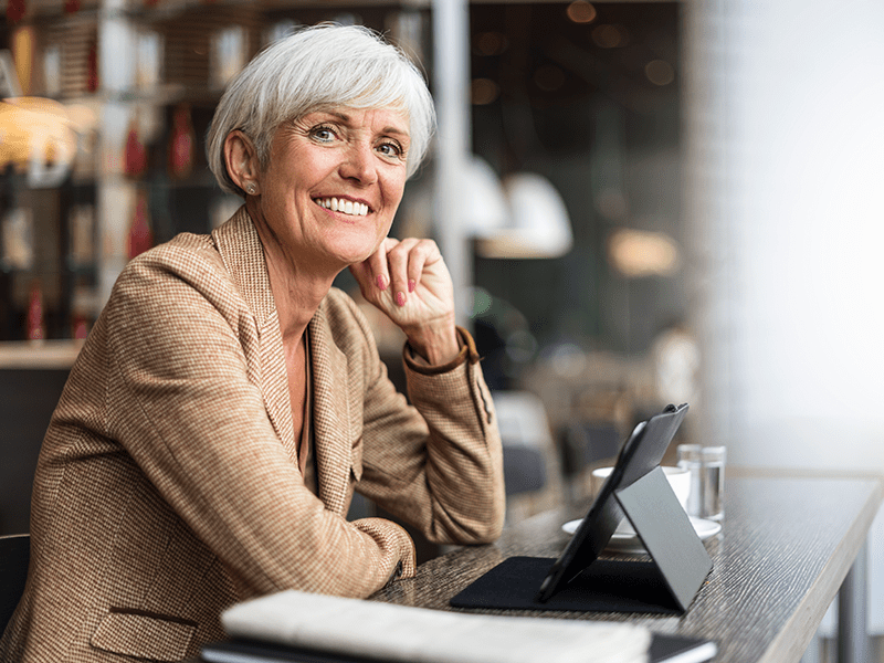 A happy looking woman working in a cafe.